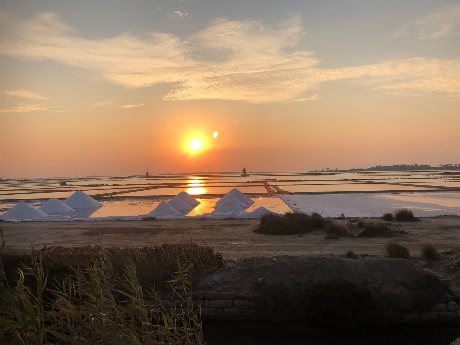 Sunset reflected across the Sicilian salt pans