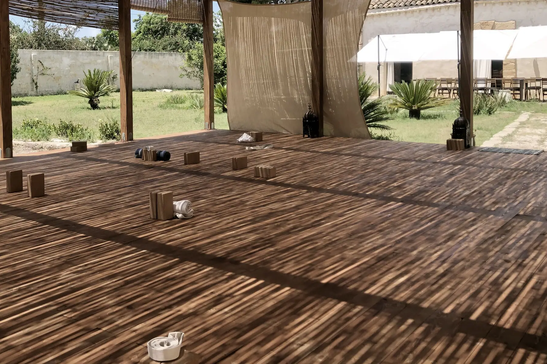 Open-air Salinara practice deck with yoga props set out